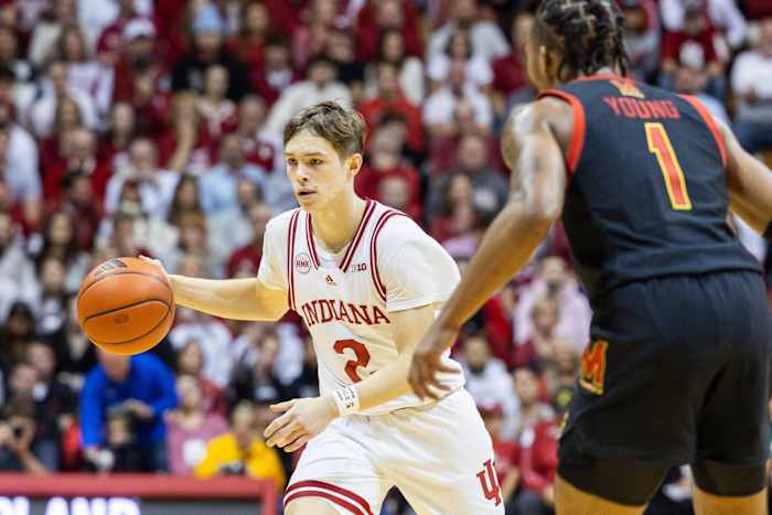 Gabe Cupps (2) dribbles the ball while Maryland Terrapins guard Jahmir Young (1) defends.